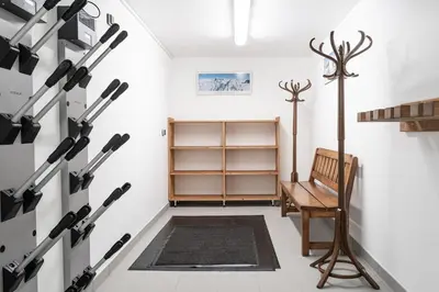 a room with a wall of baseball bats at Appartement JASIONE-MEGEVE in Megève