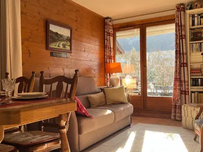 a living room with a couch and a table at Charmant 3 Pièces Sud, Piscine & Animaux Acceptés - FR-1-629-155 in Samoëns