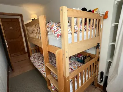 a wooden bunk bed in a small room at Charmant 3 Pièces Sud, Piscine & Animaux Acceptés - FR-1-629-155 in Samoëns