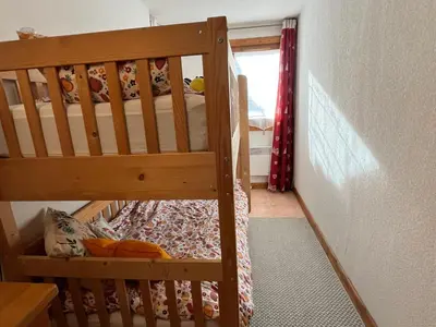 a wooden bunk bed in a room with a window at Charmant 3 Pièces Sud, Piscine & Animaux Acceptés - FR-1-629-155 in Samoëns