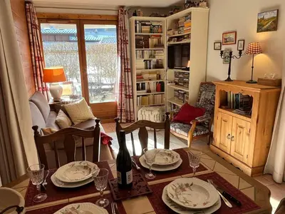 a living room with a table with plates on it at Charmant 3 Pièces Sud, Piscine & Animaux Acceptés - FR-1-629-155 in Samoëns