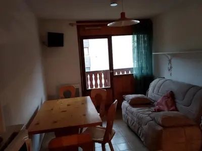 a living room with a couch and a wooden table at Charmant Appartement au Centre, Animaux Admis, 4 pers. - FR-1-836-64 in Arâches-la-Frasse
