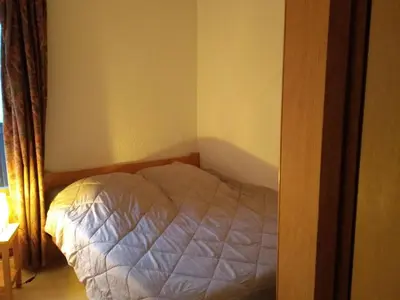 a small bedroom with a bed in the corner at Charmant Appartement au Centre, Animaux Admis, 4 pers. - FR-1-836-64 in Arâches-la-Frasse