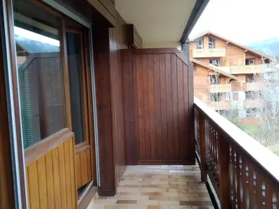 a balcony of a house with a wooden door at Charmant Appartement au Centre, Animaux Admis, 4 pers. - FR-1-836-64 in Arâches-la-Frasse