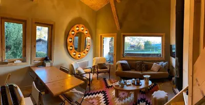 a living room with a couch and a table at Soul Megève Panoramic View, Fireplace, Parking in Megève