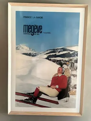 a framed picture of a woman sitting on a ski slope at Soul Megève Panoramic View, Fireplace, Parking in Megève