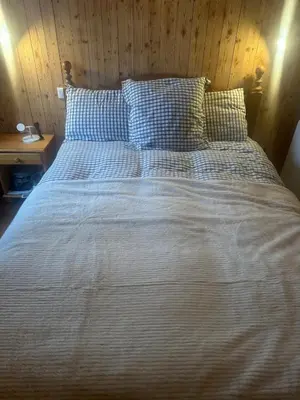 a large bed with blue and white sheets and pillows at Soul Megève Panoramic View, Fireplace, Parking in Megève