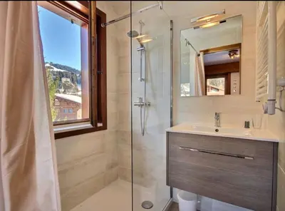 a bathroom with a shower and a sink and a mirror at Soul Megève Panoramic View, Fireplace, Parking in Megève