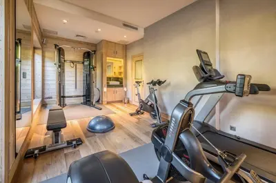 a gym with several exercise bikes in a room at Chalet Le 34 Megève - Chalet dexception in Le Planellet