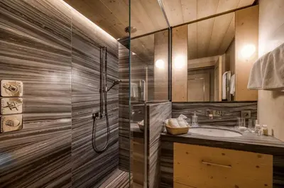 a bathroom with a shower and a sink at Chalet Le 34 Megève - Chalet dexception in Le Planellet