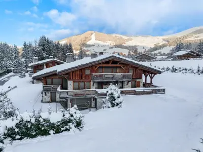 a log cabin with snow on the ground at Chalet Le 34 Megève - Chalet dexception in Le Planellet