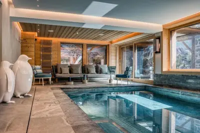 a house with a swimming pool in a room at Chalet Le 34 Megève - Chalet dexception in Le Planellet