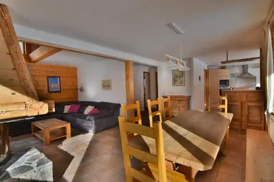a living room with a couch and a table at Chalet vallée de Chamonix, vue glaciers MontBlanc by ImmoConciergerie in Les Houches
