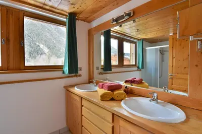 a bathroom with two sinks and a mirror at Chalet vallée de Chamonix, vue glaciers MontBlanc by ImmoConciergerie in Les Houches