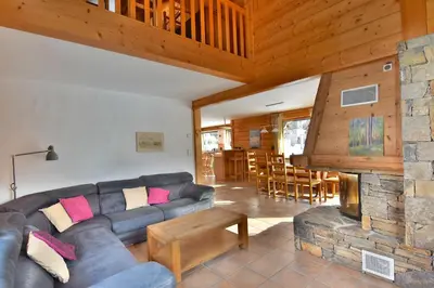 a living room with a couch and a fireplace at Chalet vallée de Chamonix, vue glaciers MontBlanc by ImmoConciergerie in Les Houches