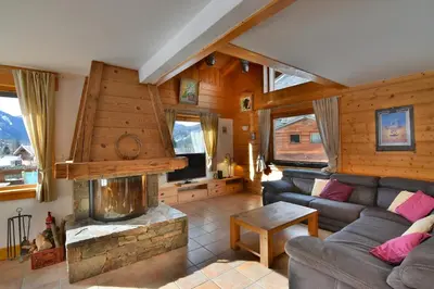 a living room with a couch and a fireplace at Chalet vallée de Chamonix, vue glaciers MontBlanc by ImmoConciergerie in Les Houches