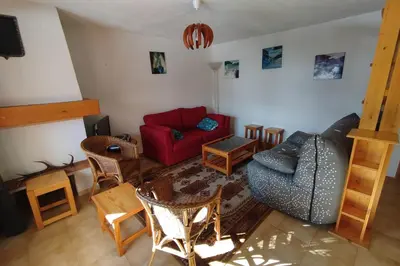 a living room with a red couch and chairs at Apt or chalet near the village Combloux in Combloux