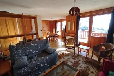 a living room with a couch and a table and chairs at Apt or chalet near the village Combloux in Combloux