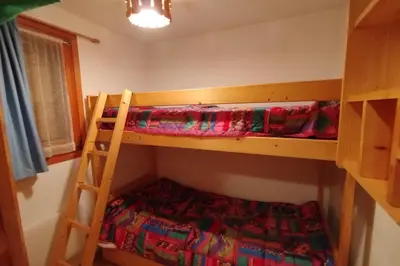 a bedroom with two bunk beds and a ladder at Apt or chalet near the village Combloux in Combloux