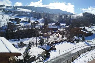 a snow covered mountain with houses and a resort at Apt or chalet near the village Combloux in Combloux
