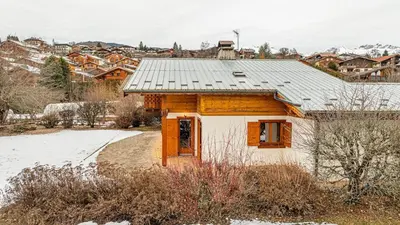 a house with a solar roof on top of it at White Chalet in Combloux