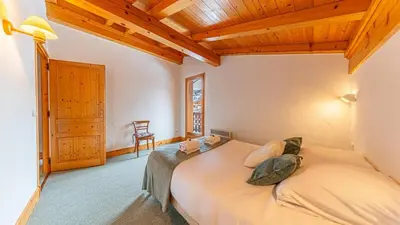 a bedroom with a bed with pillows on it at White Chalet in Combloux