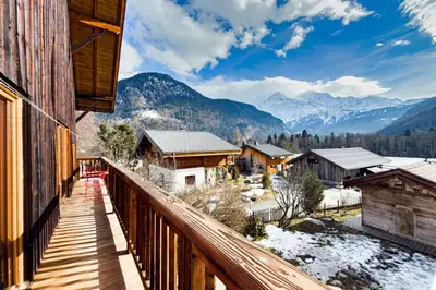 a balcony of a house with a view of mountains at Apartment near the slopes in Servoz in Servoz