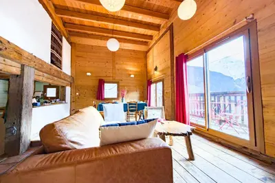 a living room with a couch and a large window at Apartment near the slopes in Servoz in Servoz