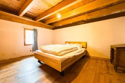 a bedroom with a bed in a room with wooden ceilings at Apartment near the slopes in Servoz in Servoz