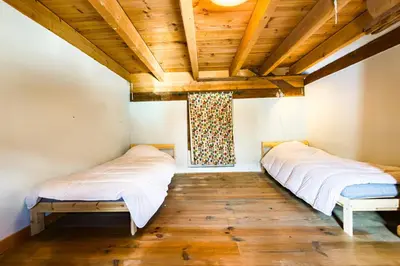 two beds in a room with a wooden ceiling at Apartment near the slopes in Servoz in Servoz