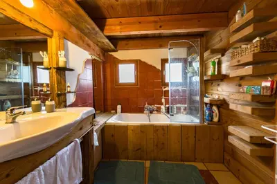 a bathroom with a tub and a sink and a bath tub at Apartment near the slopes in Servoz in Servoz