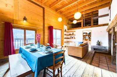 a dining room with a table and a couch at Apartment near the slopes in Servoz in Servoz
