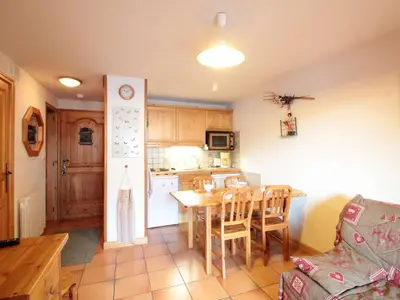 a kitchen and dining room with a table and chairs at 2 Pièces Cabine près des Pistes avec Parking Inclus - FR-1-572-352 in Arâches-la-Frasse