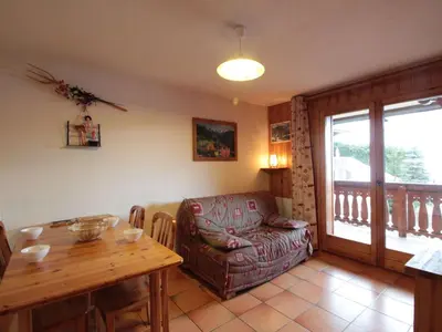 a living room with a couch and a table and a chair at 2 Pièces Cabine près des Pistes avec Parking Inclus - FR-1-572-352 in Arâches-la-Frasse