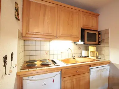 a kitchen with a sink and a microwave at 2 Pièces Cabine près des Pistes avec Parking Inclus - FR-1-572-352 in Arâches-la-Frasse
