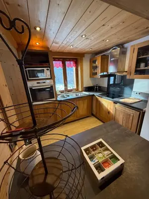 a kitchen with a table with a bowl of food at Chalet du Gouter in Les Houches