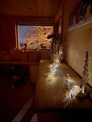 a living room with a table with lights on it at Chalet du Gouter in Les Houches
