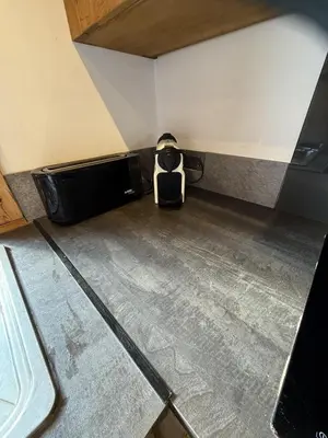 a toaster oven sitting in the corner of a room at Chalet du Gouter in Les Houches
