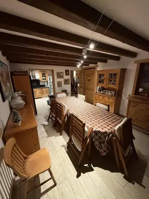 a kitchen with a large table with chairs and a kitchen with at Chalet du Gouter in Les Houches