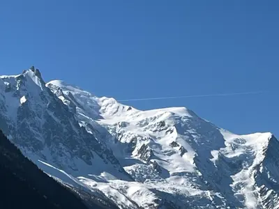 a snow covered mountain with a blue sky at Bel appartement avec vue exceptionnelle in Chamonix-Mont-Blanc