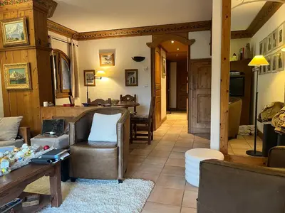 a living room with a couch and a table at Bel appartement avec vue exceptionnelle in Chamonix-Mont-Blanc