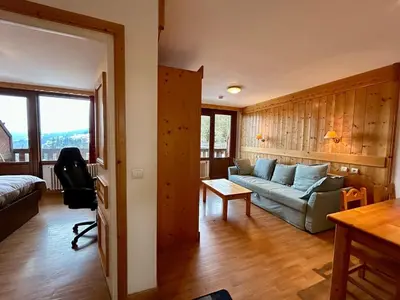 a living room with a couch and a table at La grande cordée in Combloux