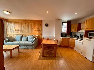 a living room with a couch and a table at La grande cordée in Combloux