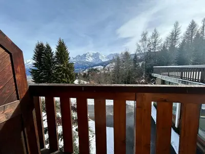 a balcony with a view of a snowy mountain at La grande cordée in Combloux