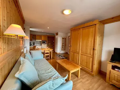 a living room with a couch and a table at La grande cordée in Combloux