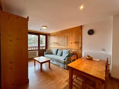 a living room with a couch and a table at La grande cordée in Combloux