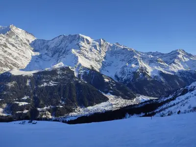 a snow covered mountain range with a ski slope at Apartment Vent d'Est by Interhome in Mémontel