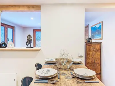 a dining room with a wooden table and chairs at Apartment Vent d'Est by Interhome in Mémontel