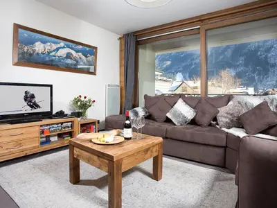 a living room with a couch and a table at Apartment Le Paradis Ski Wohnung by Interhome in Chamonix-Mont-Blanc