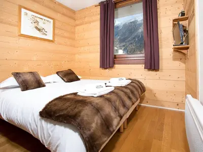 a bedroom with a large bed with a large window at Apartment Le Paradis Ski Wohnung by Interhome in Chamonix-Mont-Blanc